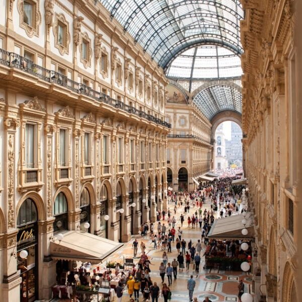 Interior view of Galleria Vittorio Emanuele II in Milan, showcasing its stunning architecture and bustling crowds.