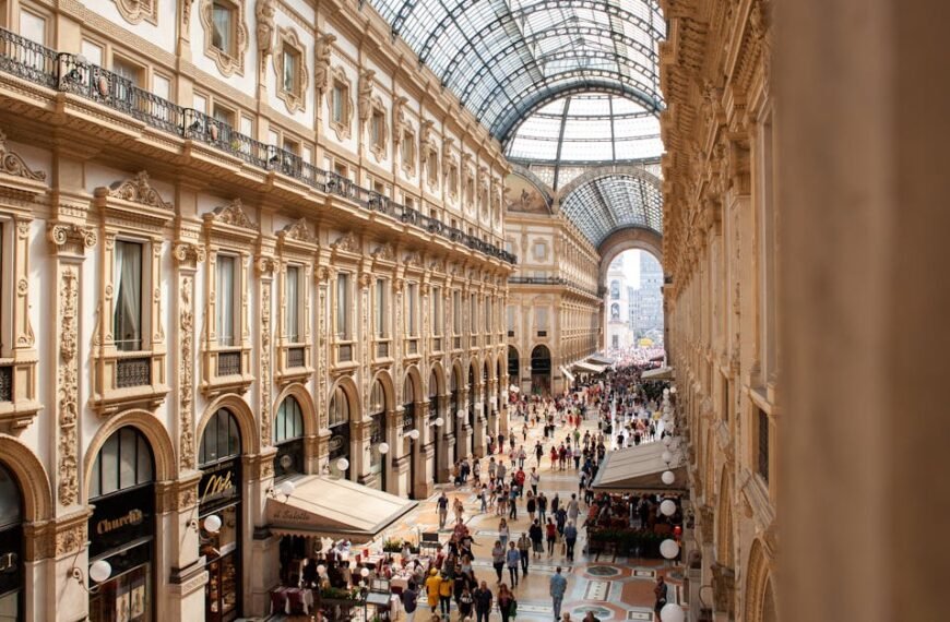 Interior view of Galleria Vittorio Emanuele II in Milan, showcasing its stunning architecture and bustling crowds.